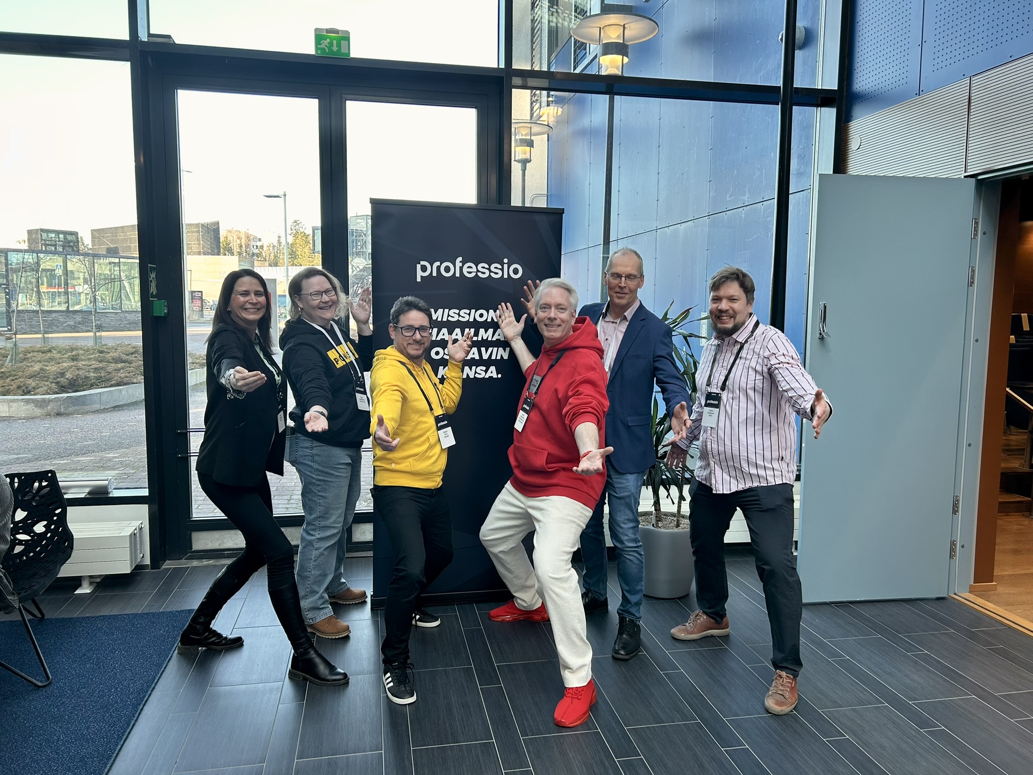 "The Pose" featuring Virpi Tuohisto, Tanja Jauhiainen, Szilard Szell, Mikko Paloheimo, Antti Jääskö and Pekka Pönkänen A Group of people standing in front of a banner